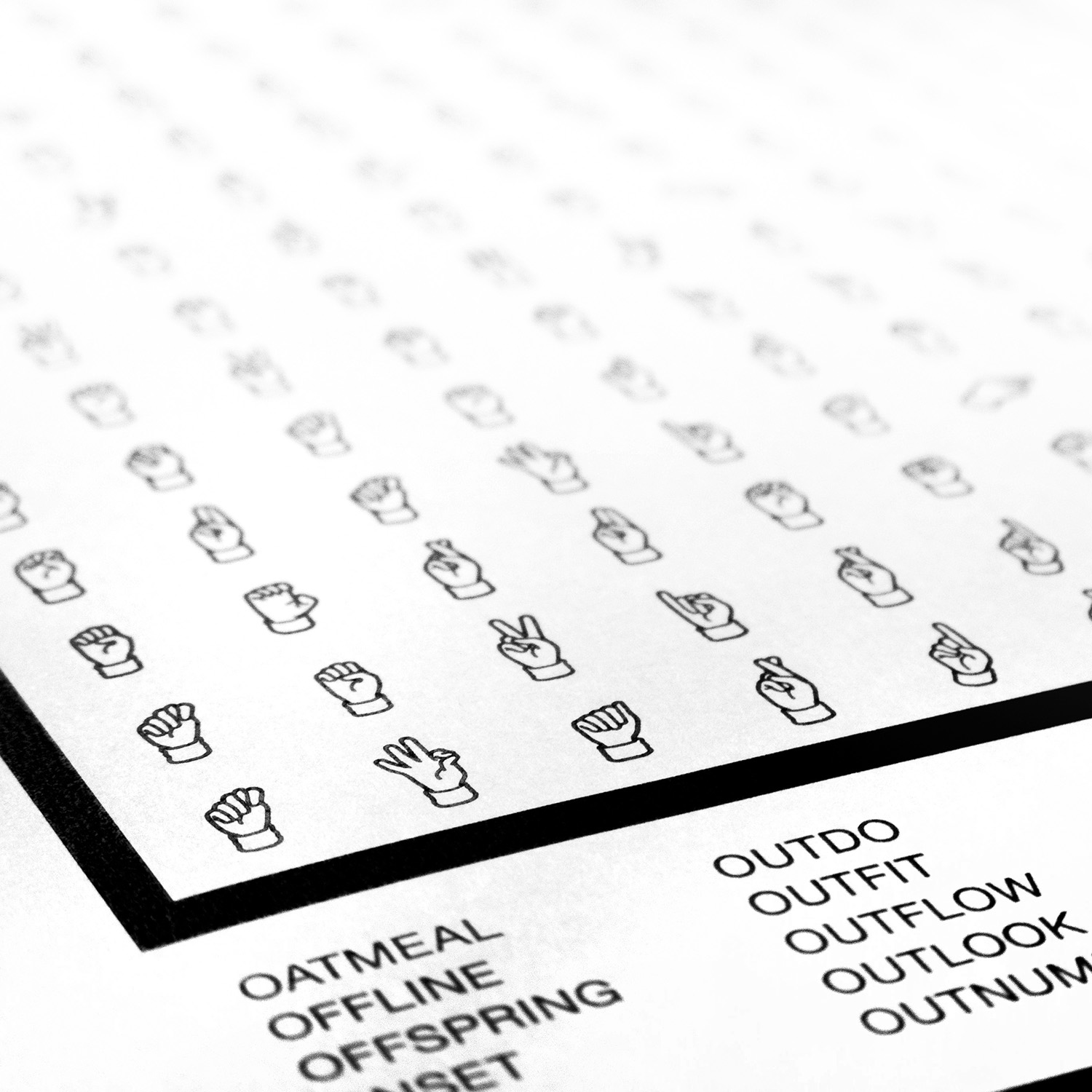 Close-up of a puzzle page: a grid of ASL hand shapes, with the word list printed in regular letters below